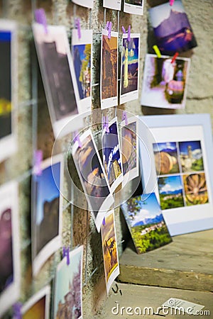 Snaphots of moments printed pinned to the walls in a multitude of colors Editorial Stock Photo
