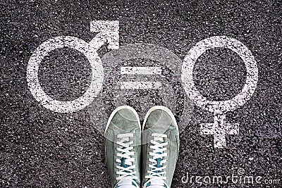 Sneaker shoes on asphalt background with gender symbols, gender equality concept Stock Photo