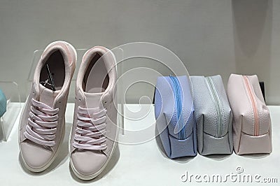 Sneaker shoes and handbags on display Stock Photo