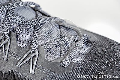 Sneakers close-up. Shoelaces of new sports shoes in gray, lacing sneakers close-up, top view. Mesh elastic laces for fitness. Stock Photo
