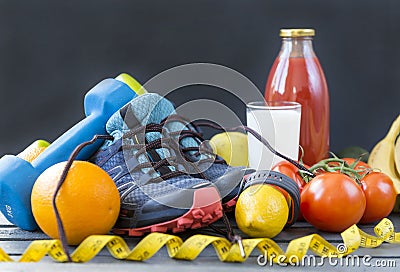 sneakers , dumbbells ,oranges, tomatoes, lemon, sports bracelet, tomato juice , milk, fruits and vegetables Stock Photo
