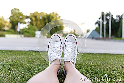 Sneakers on green grass in city park Stock Photo