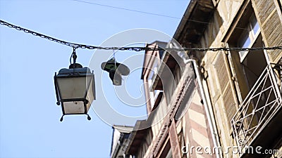 Sneakers are hung on wires. Action. Sneakers hanging from cable wires on background of house and blue sky. Bullies had Stock Photo