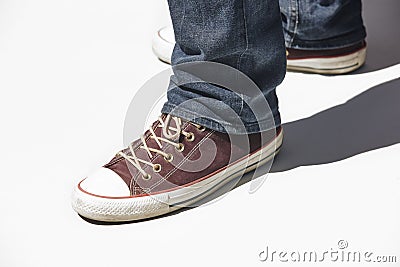 Sneakers and jeans isolated on white. Youth casual wear. Horizontal Stock Photo