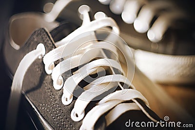 Sneakers with untied white laces Stock Photo