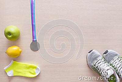 Sneakers, yellow socks, green Apple, yellow lemon, medal, sport Stock Photo