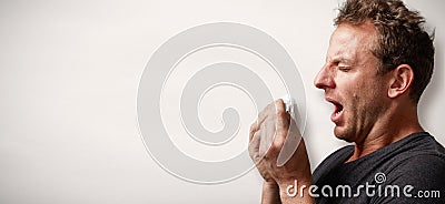 Sneezing man with cold Stock Photo