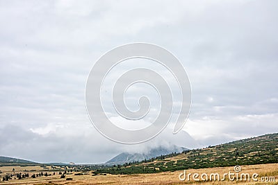 Snezka, Krkonose, border of Poland and Czech Republic. Beautiful panoramic view of the mountain. Peak of the mountain in the fog Stock Photo