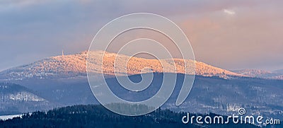Snieznik Massif, Czarna Gora peak, snow-covered forests in the mountains at sunset Stock Photo