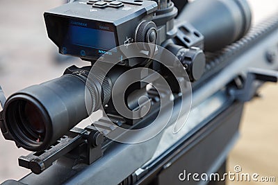 Sniper gun, optics scopes close up. Elements of the sniper rifle with tactical body. Selective focus Stock Photo