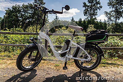 Folding Electric Bicycle Parked Along the Centenal Rail Trail Stock Photo