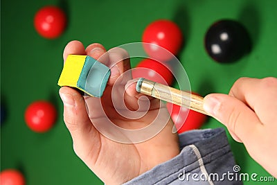 Snooker cue, chalk and hands Stock Photo