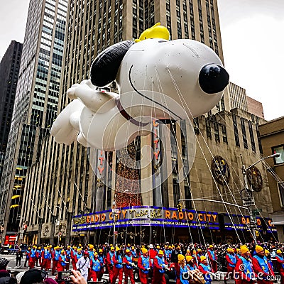 Snoopy balloon floats in the air during the annual Macy`s Thanksgiving Day parade along Avenue of Americas Editorial Stock Photo