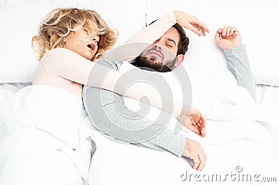 Snore. Couple sleep together in bed Stock Photo