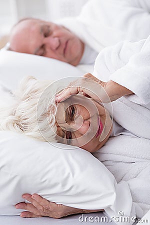 Snoring husband and his wife Stock Photo