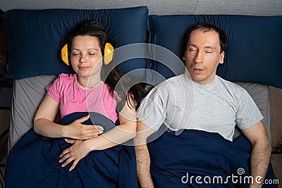 Snoring Husband Man And Partner Woman With Headphones Stock Photo