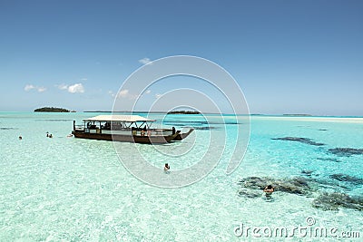 Snorkeling in turquoise clear water with coral reefs, South Pacific Ocean with Island Editorial Stock Photo