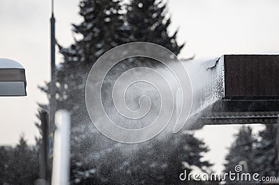 Snow blowing off from the roof Stock Photo