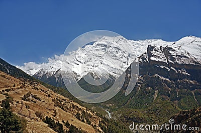 Snow-capped peak of Annapurna II dominating the valley of the Marsyangdi river, Nepal Stock Photo