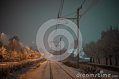 Snow capped railway track or railroad covered with snow during night time Stock Photo