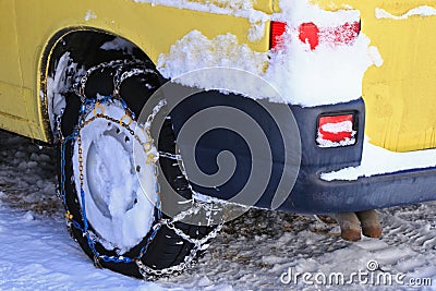 Snow chains (tire chains) attached to the drive wheels Stock Photo