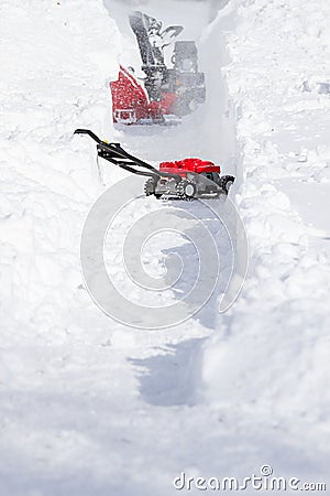 Snow Cleaning Machine Opening Way on Driveway Stock Photo