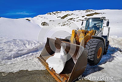 Snow clearing excavator in Aran Valley Stock Photo