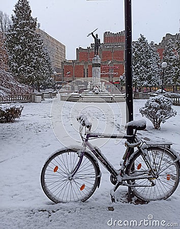 snow-covered bicycle parked in the town square, Jagodina, Serbia Editorial Stock Photo