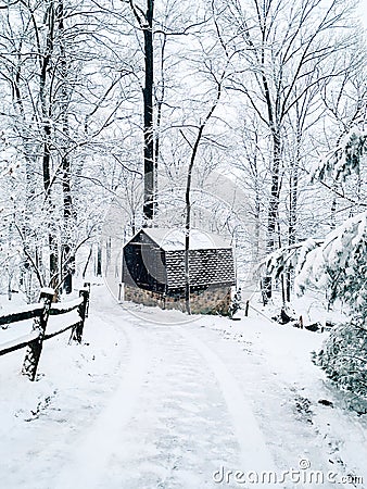 Snow covered country road and small barn in winter, Glen Rock, Pennsylvania Stock Photo