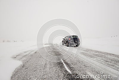 Fields and a road in winter and a car Stock Photo