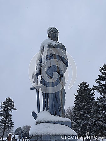 Snow covered gravestone statue in Indiana Stock Photo