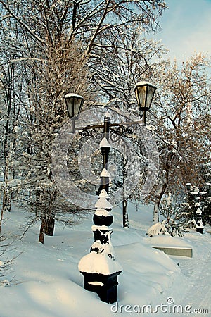 Snow covered lamppost along roadside in winter Park Stock Photo