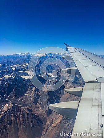 Snow covered mountain airplane window view Stock Photo