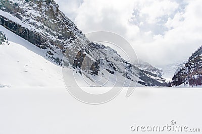Snow Covered Mountain Behind Frozen Lake Stock Photo