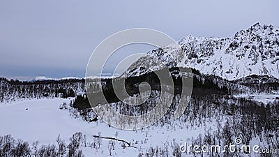 Snow covered mountains on Hinnoya near Austerstraumen bru in winter in Norway Stock Photo