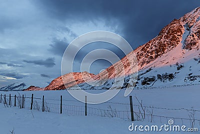 Snow-covered mountains in sunset glow Stock Photo