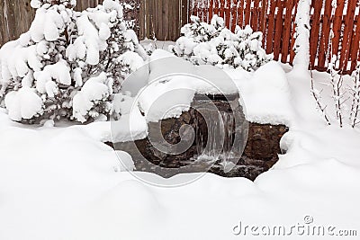 Snow covered outdoor water feature Stock Photo