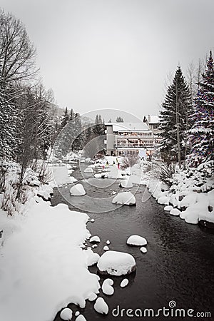 A snow covered river running in Vail, Colorado. Stock Photo