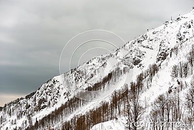 Snow-covered slope of the mountain on a cloudy day Stock Photo