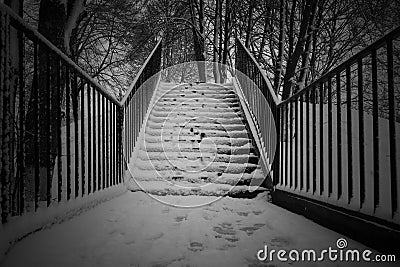 Snow covered stairs in a park with fresh human foot steps. Stock Photo