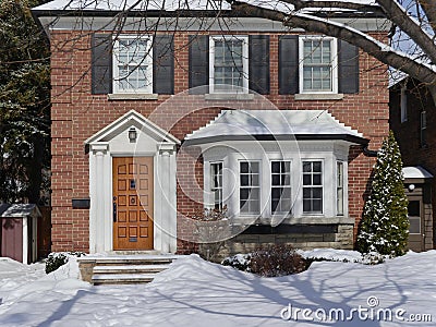 Snow covered suburban house Stock Photo