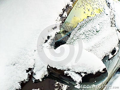 Snow-covered windshield, side window and left rear-view mirror Stock Photo