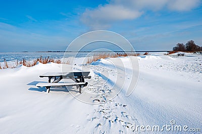 Snow dunes at a lake in Winter Stock Photo
