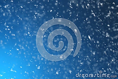 Snow flakes falling on blue background Stock Photo