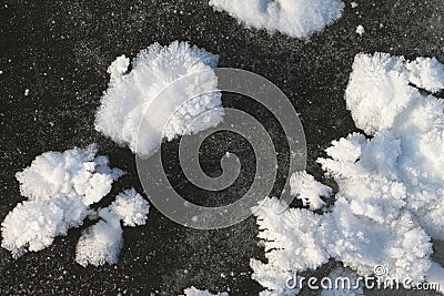 Snow freakish outgrowths on ice of the frozen river Stock Photo