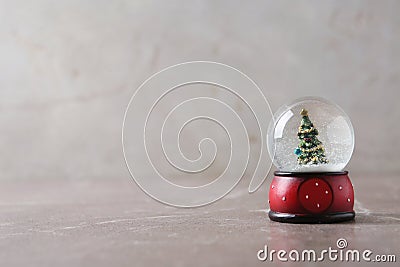 Snow globe with Christmas tree on marble table Stock Photo