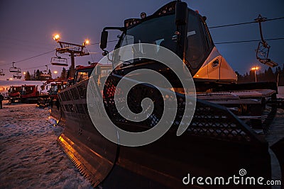 Snow groomers sleeping after the hard day on the Snow Ski Resort Stock Photo