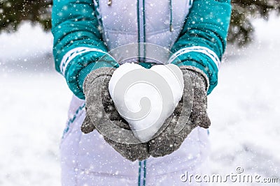 Snow heart in woman's heand. Winter romantic concept Stock Photo