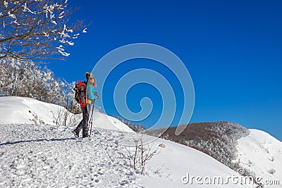 Snow hiker in the mountains, middle aged woman Stock Photo