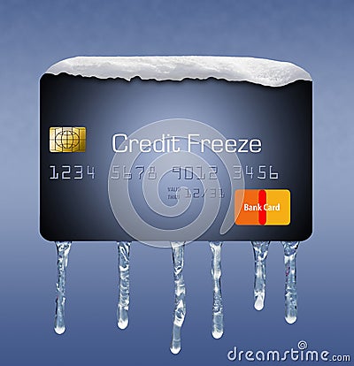 Snow and ice on a credit card illustrate the theme of putting a freeze on your credit report. Stock Photo